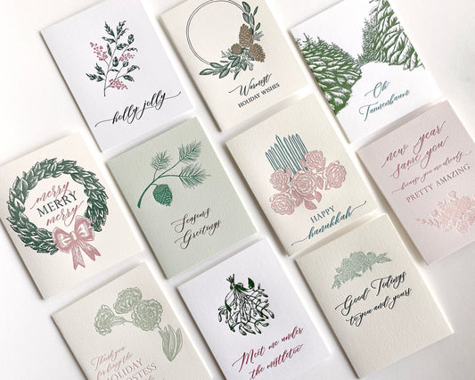 Green letterpress holiday card with branch and pinecone that reads "Season's Greetings" by Rust Belt Love