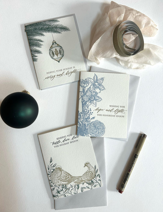 Letterpress holiday card with an ornament on it that reads "hoping your holiday is merry and bright" by Rust Belt Love