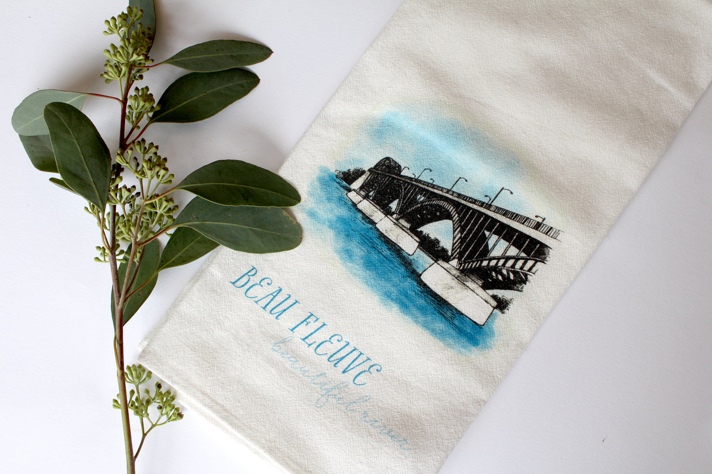 White Tea Towel with peace bridge illustration that says "beau fleuve beautiful river" by Rust Belt Love