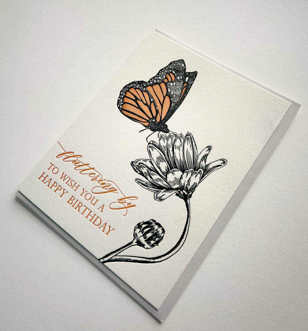 Letterpress birthday card with a butterfly and flower that says " Fluttering by to wish you a happy birthday" by Rust Belt Love 