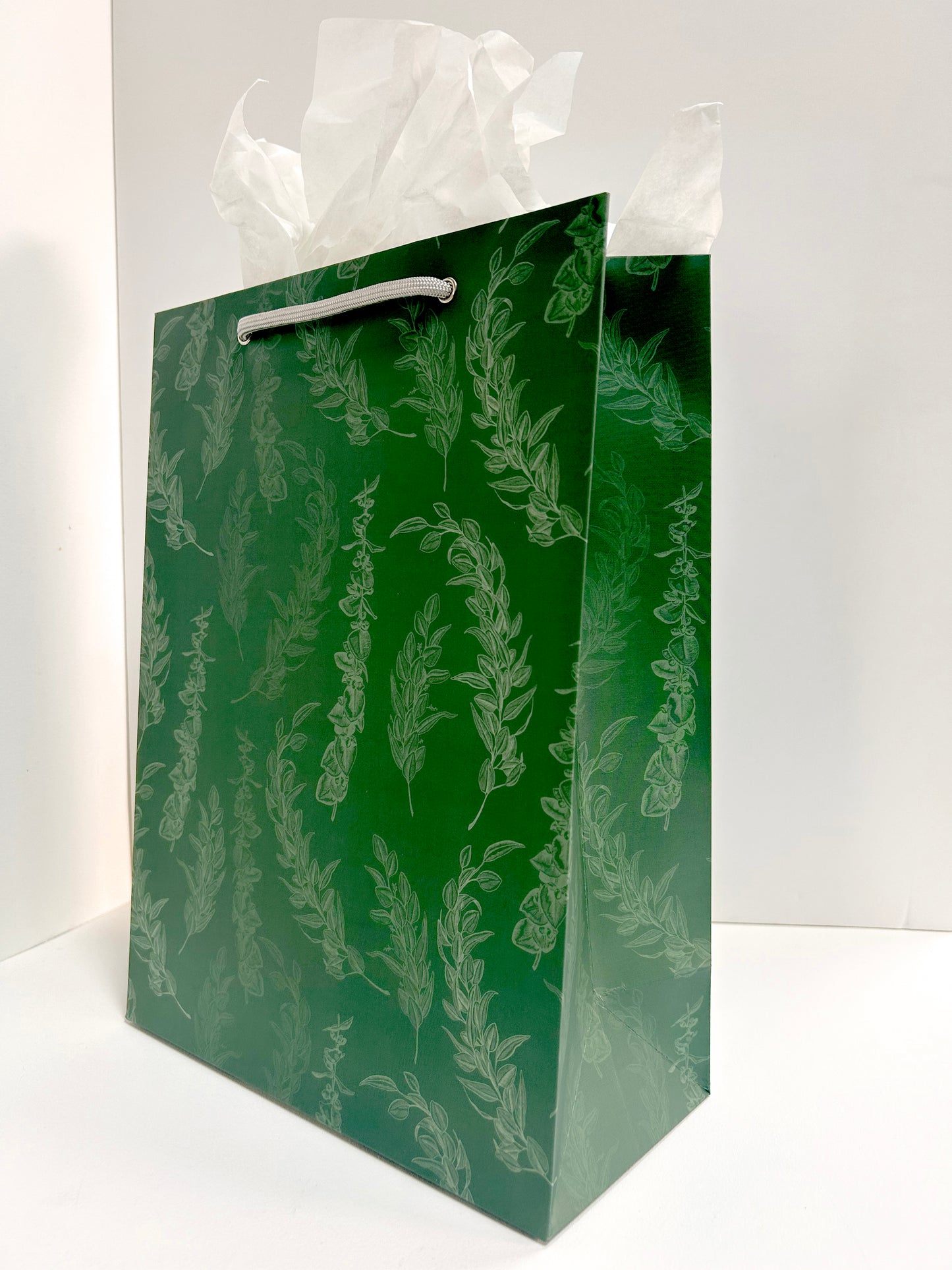 Angled standing picture of green gift bag with eucalyptus print by Rust Belt Love