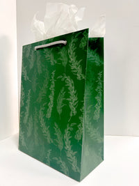 Angled standing picture of green gift bag with eucalyptus print by Rust Belt Love
