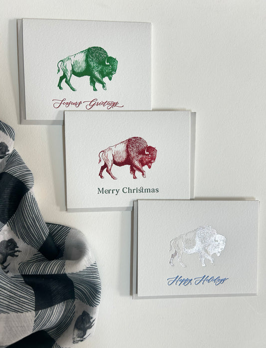 Green foil buffalo holiday card that reads "Season's Greetings" from Rust Belt Love