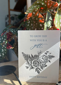 Style shot of letterpress birthday card with black florals that reads "To grow old with you is a gift happy birthday" by Rust Belt Love