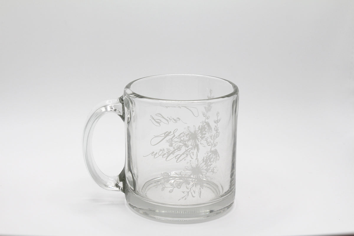 White ink on clear glass mug with flowers and that says "grow wild" by Rust Belt Love
