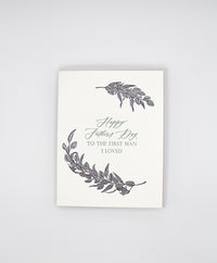 Letterpress father's day card with black greenery that reads "Happy Father's Day to the first man I loved"by Rust Belt Love