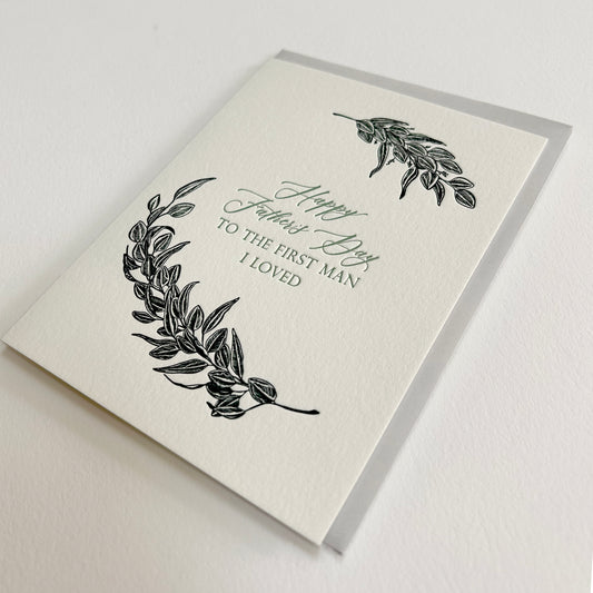 Letterpress father's day card with black greenery that reads "Happy Father's Day to the first man I loved"by Rust Belt Love