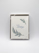 Box of letterpress holiday cards with greenery that says "Happy Holidays" by Rust Belt Love