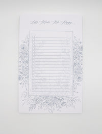 5.5 by 8.5 notepad with lined sheets with blue florals that says "Lists make me happy" by Rust Belt Love