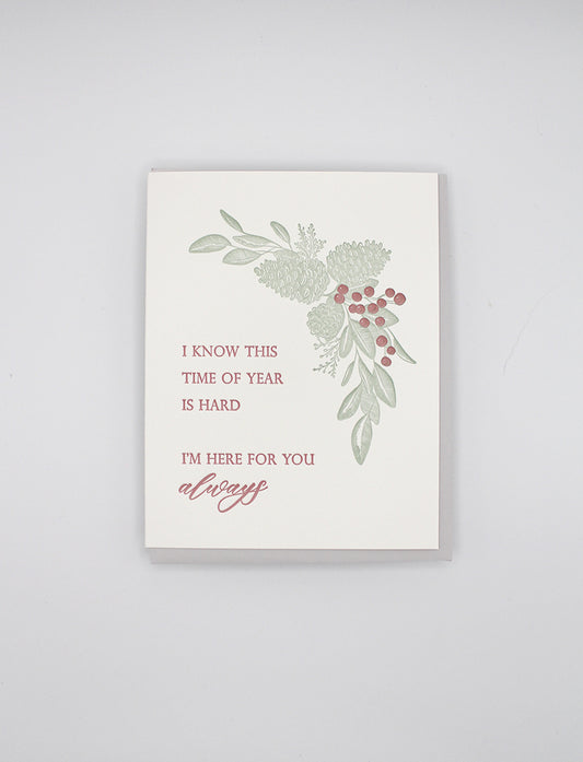 Box of letterpress holiday cards with pinecones that says " I Know This Time Of Year Is Hard I'm Here For You Always" by Rust Belt Love