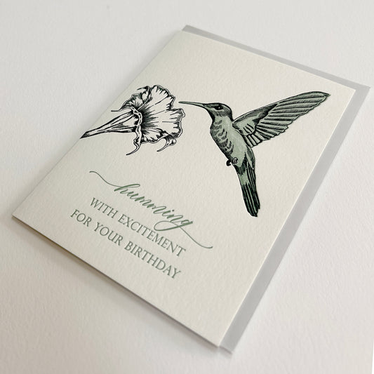 Letterpress birthday card with a flower and hummingbird that reads "Humming with excitement for your birthday" by Rust Belt Love