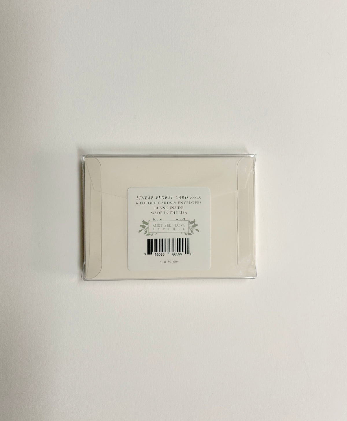Back of clear box packaging for Rust Belt Love's small note card