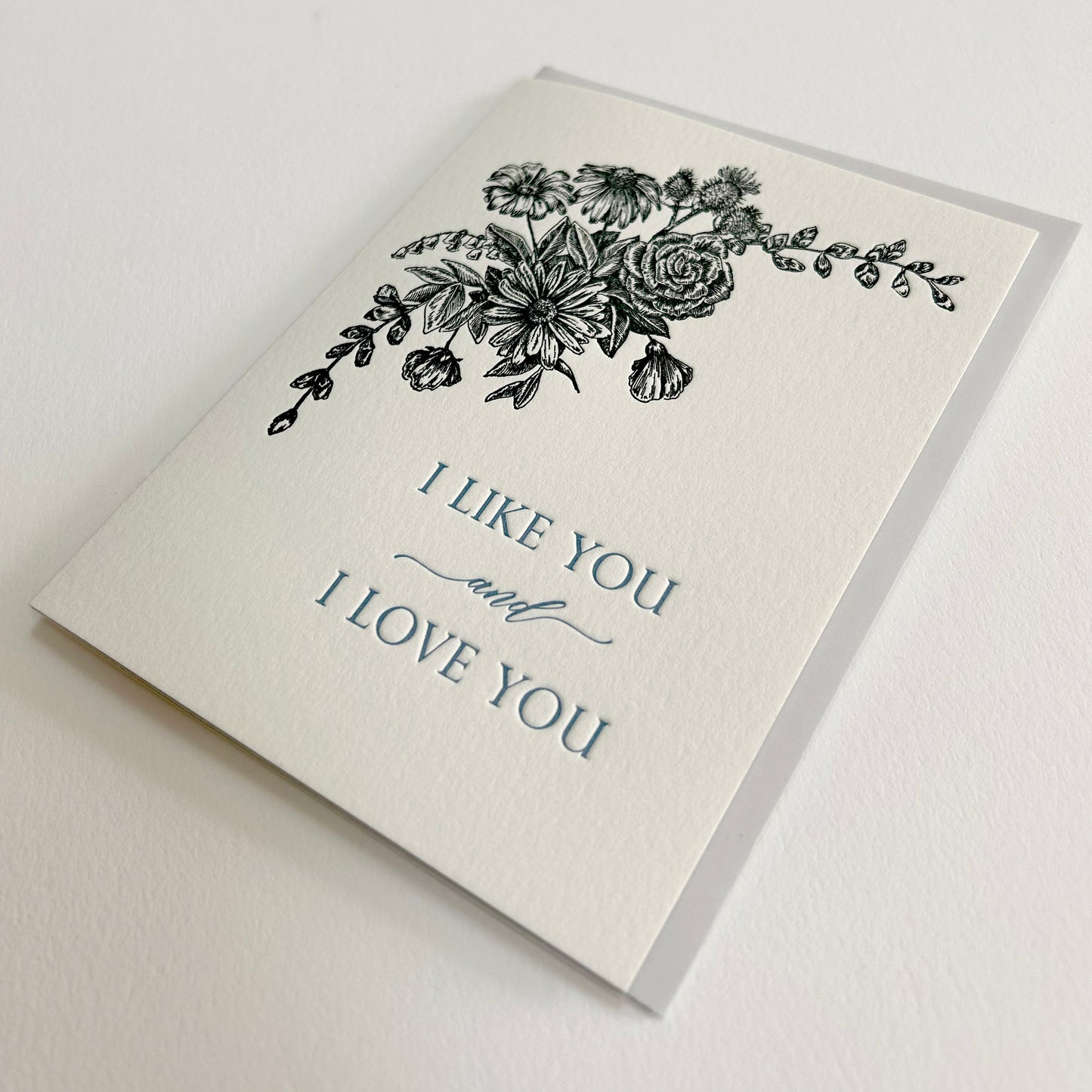 Letterpress love card with black florals that reads "i like you and i love you" by Rust Belt Love