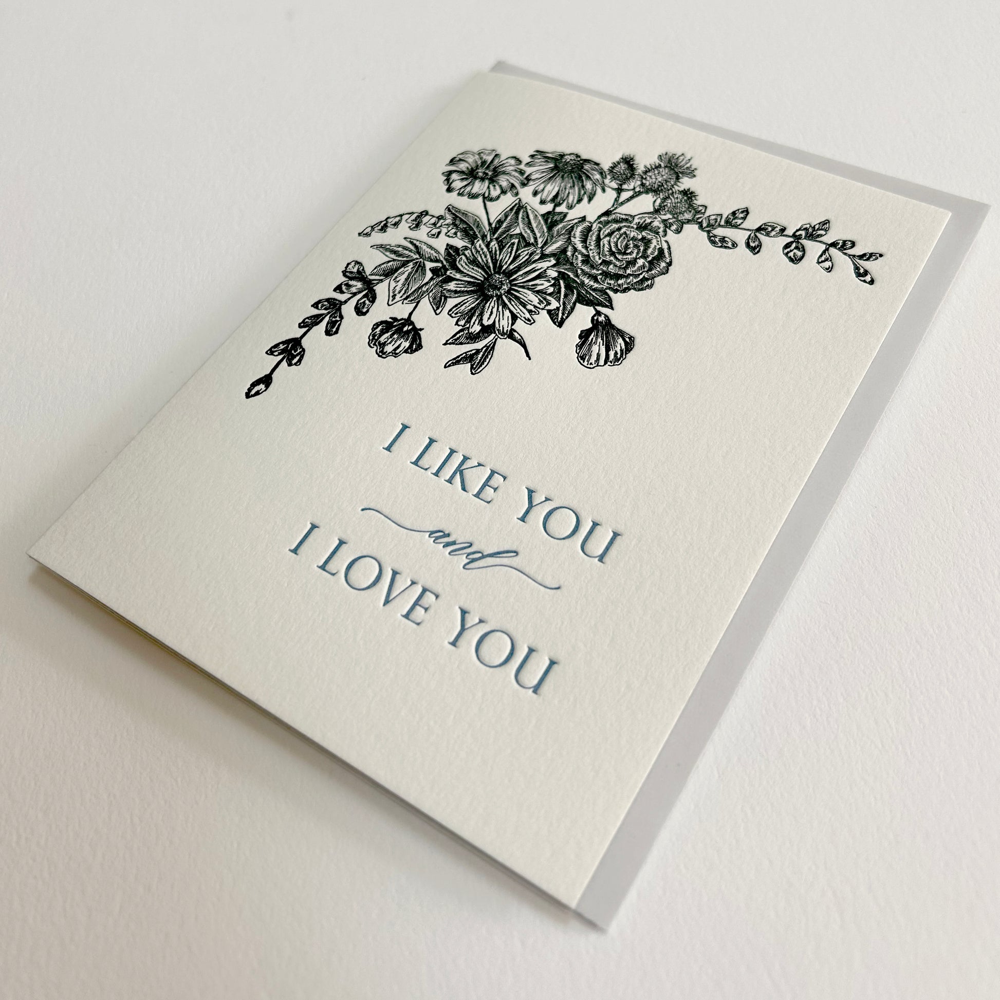Letterpress love card with black florals that reads "i like you and i love you" by Rust Belt Love