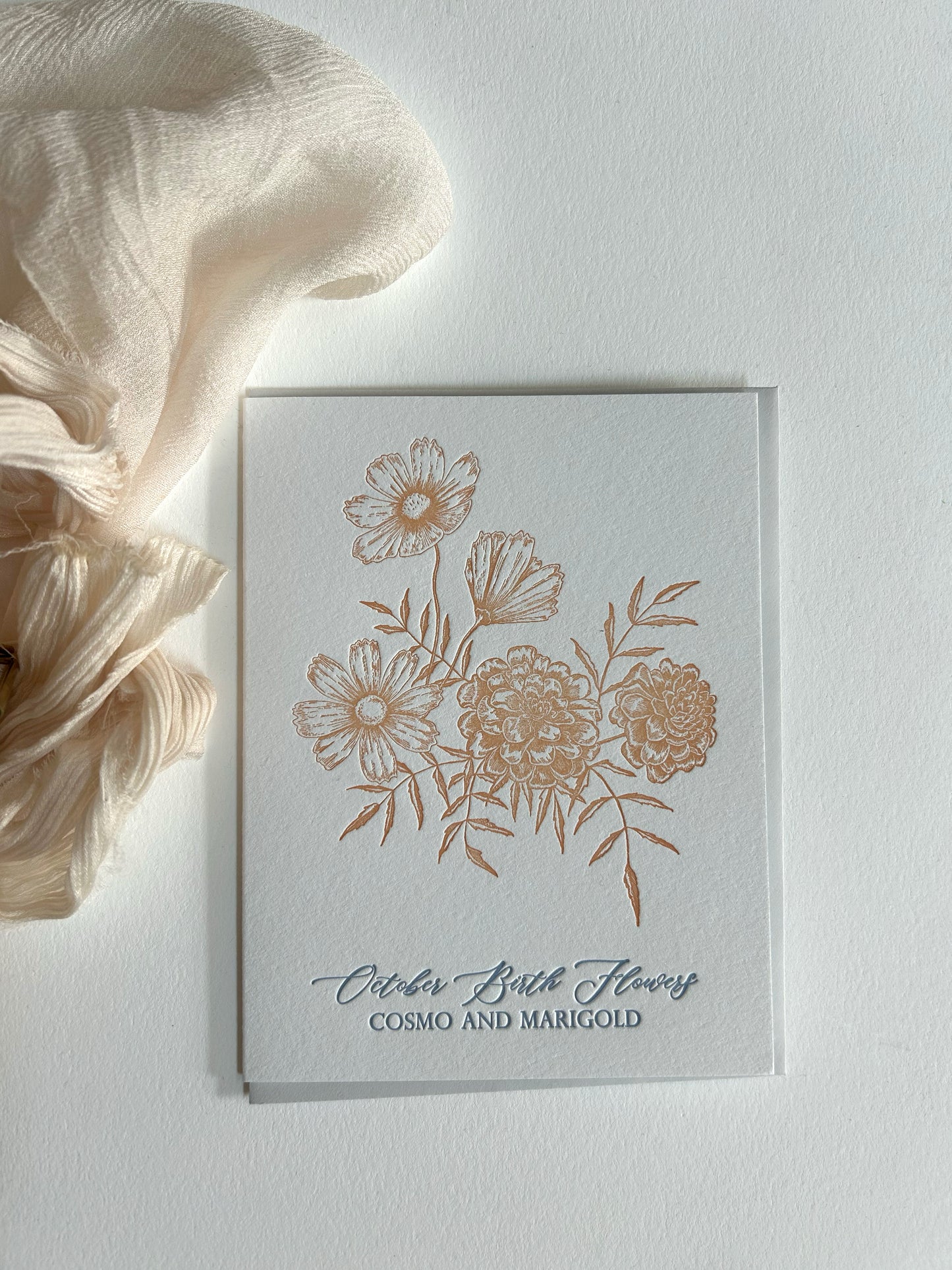 Style shot of letterpress birth flower card that reads "October birth flowers cosmo and marigold" by Rust Belt Love 