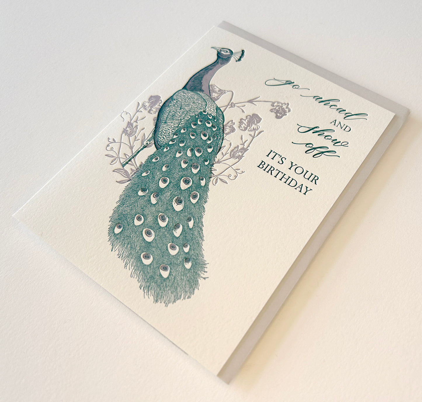 Letterpress birthday card with florals and peacock illustration that reads "Go ahead and show off it's your birthday" by Rust Belt Love