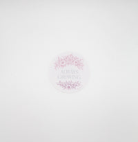 Circular pink sticker with florals that says "always growing" by Rust Belt Love