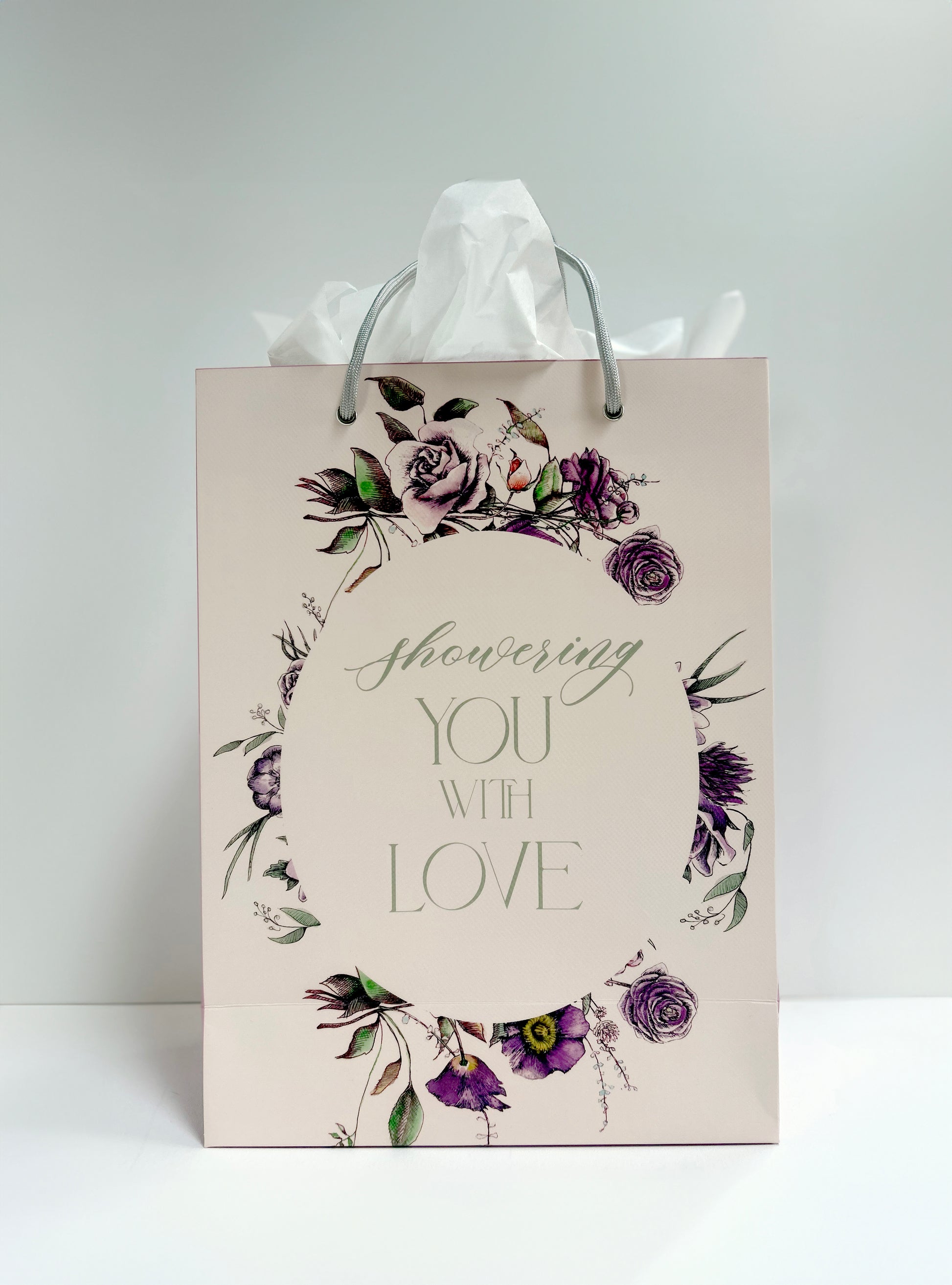 Standing pink floral gift bag that reads "Showering you with love" by Rust Belt Love