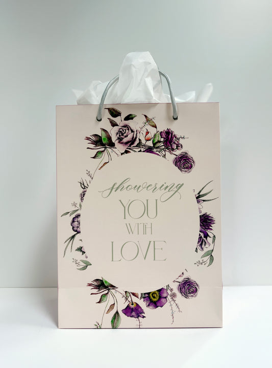 Standing pink floral gift bag that reads "Showering you with love" by Rust Belt Love