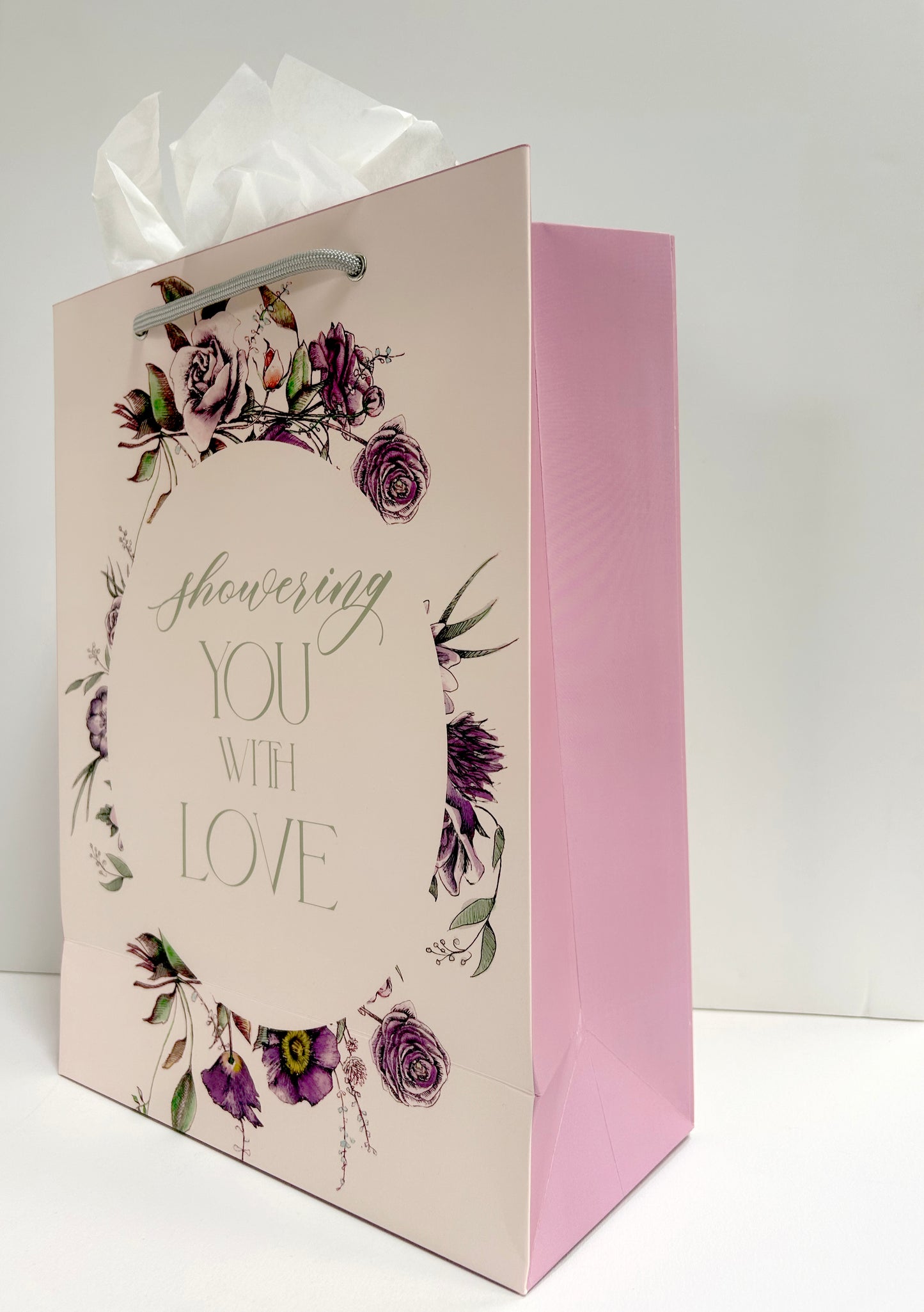 Standing pink floral gift bag that reads "Showering you with love" by Rust Belt Love