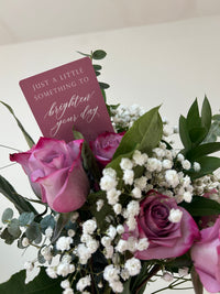 Style shot of pink minicard in a bouquet of flowers