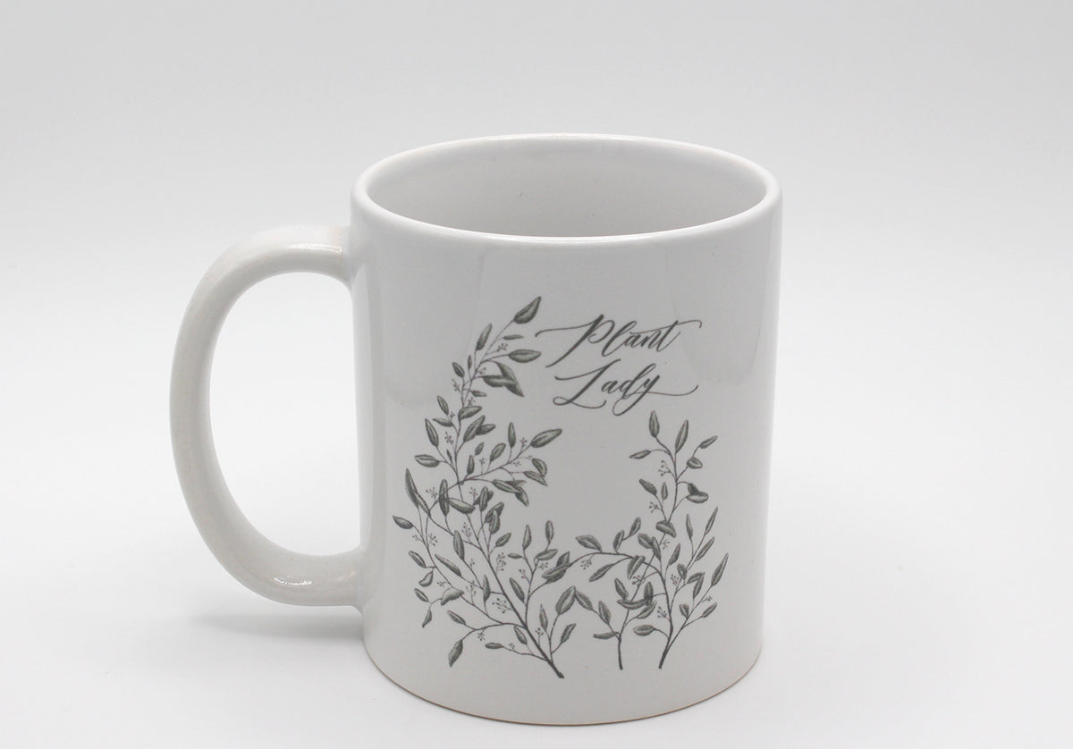 White ceramic mug with drawing of leafy greenery and words "Plant Lady" by Rust Belt Love
