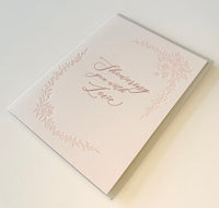 Letterpress love card with florals that says "Showering you with love" by Rust Belt Love