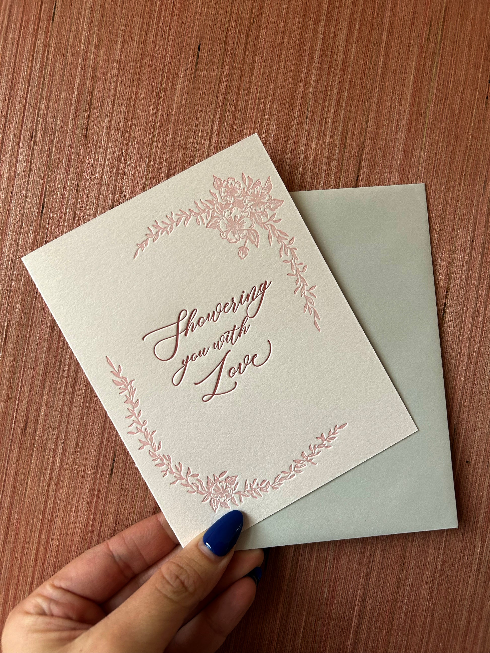 Letterpress love card with florals that says "Showering you with love" by Rust Belt Love