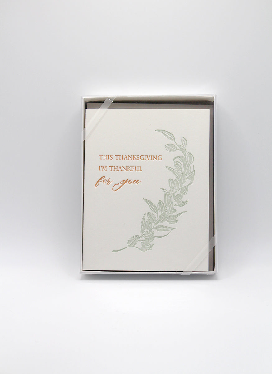 Box of letterpress holiday cards with greenery that reads "This thanksgiving i'm thankful for you" by Rust Belt Love