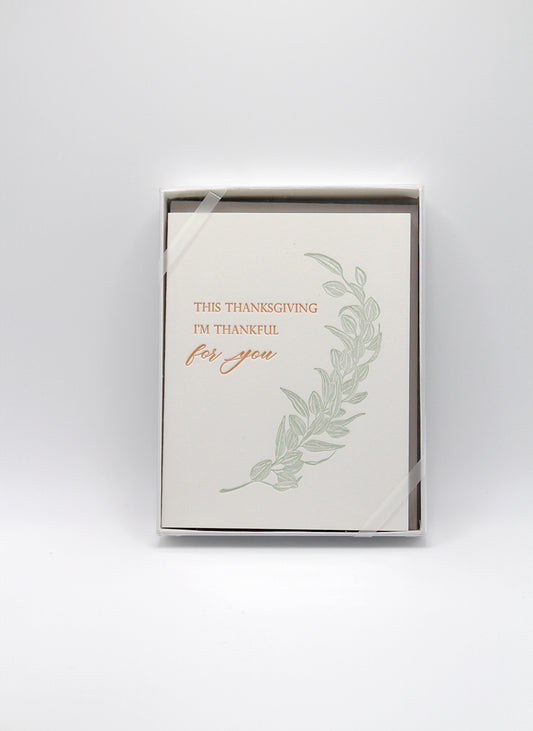 Box of letterpress holiday cards with greenery that reads "This thanksgiving i'm thankful for you" by Rust Belt Love