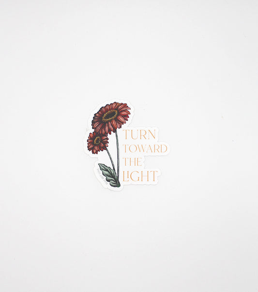 Floral sticker by Rust Belt Love that reads "turn towards the light"