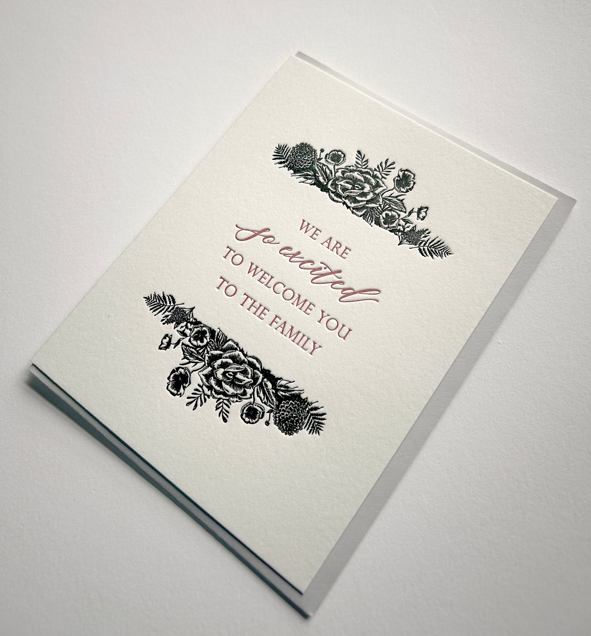 Letterpress wedding card with florals that says "We are so excited to welcome you to the family" by Rust Belt Love