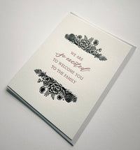 Letterpress wedding card with florals that says "We are so excited to welcome you to the family" by Rust Belt Love