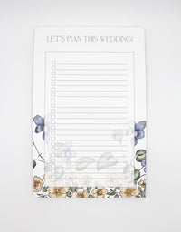 5.5 by 8.5 notepad with lined sheets with multi-colored florals that says "Let's plan this wedding!" by Rust Belt Love