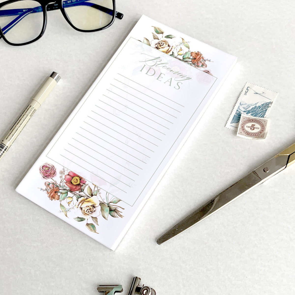 3.5 by 8.5 notepad with lined sheets with florals that says "Blooming ideas" by In Good Company