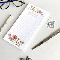 3.5 by 8.5 notepad with lined sheets with florals that says "Blooming ideas" by In Good Company