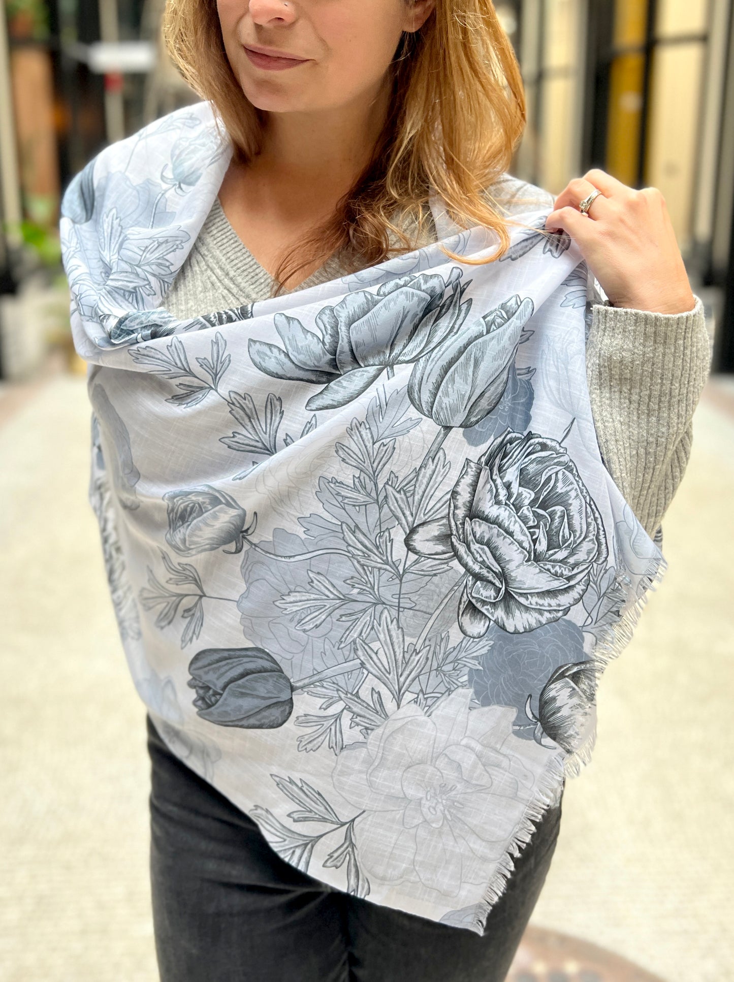 Model wearing blue floral pashmina scarf by Rust Belt Love
