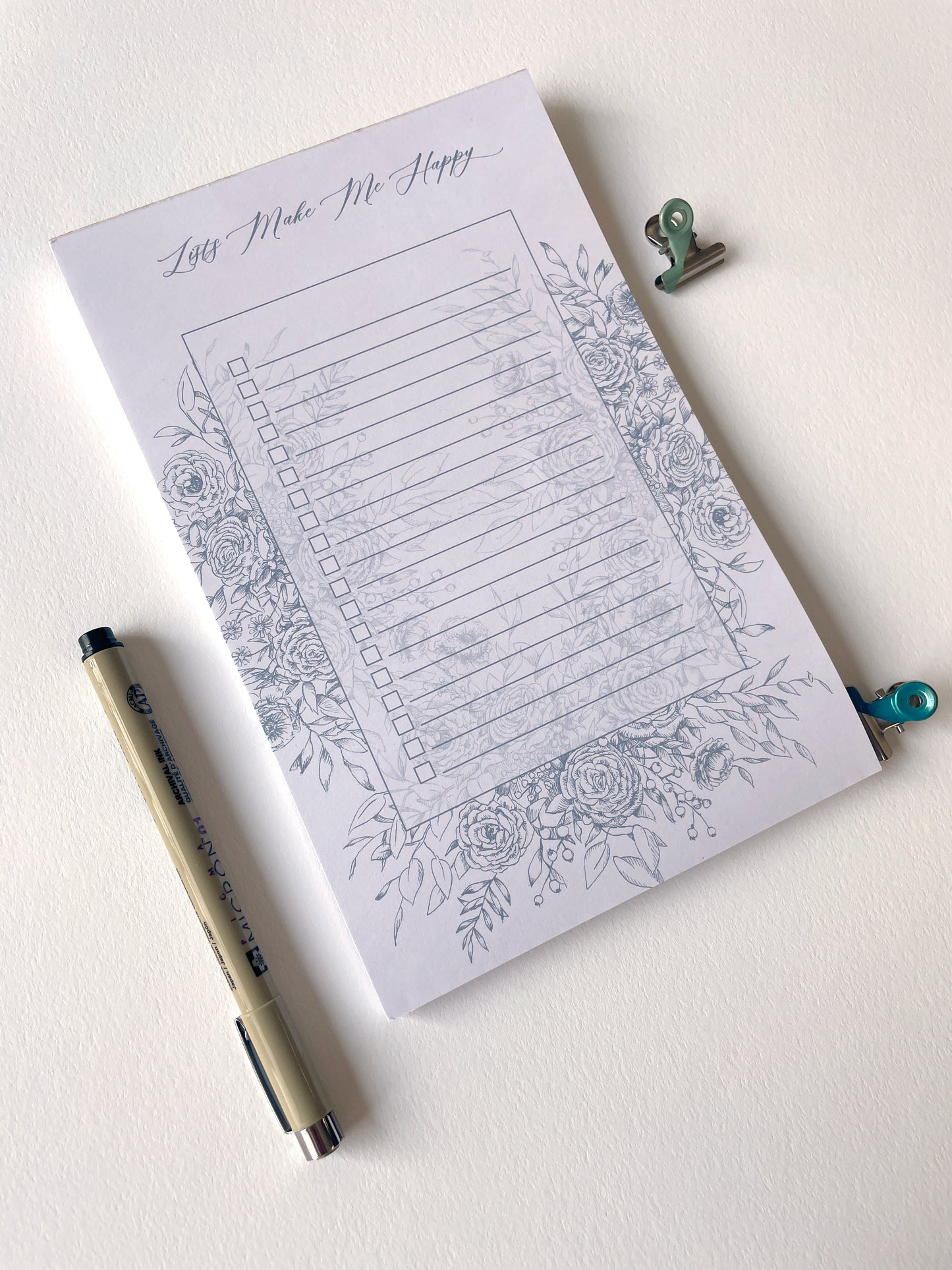 5.5 by 8.5 notepad with lined sheets with blue florals that says "Lists make me happy" by Rust Belt Love