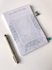 5.5 by 8.5 notepad with lined sheets with blue florals that says "Lists make me happy" by In Good Company