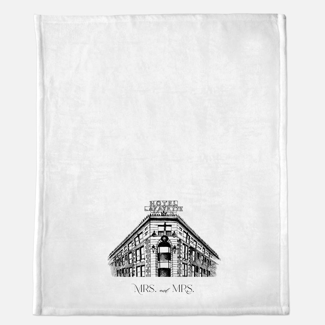 White minky blanket with Hotel Lafayette illustration that says "Mrs. and Mrs." by In Good Company