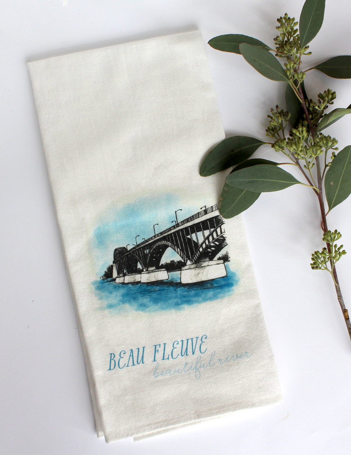 White Tea Towel with peace bridge illustration that says "beau fleuve beautiful river" by In Good Company