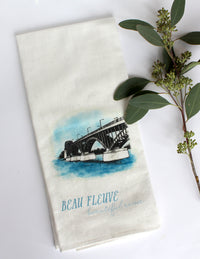 White Tea Towel with peace bridge illustration that says "beau fleuve beautiful river" by In Good Company
